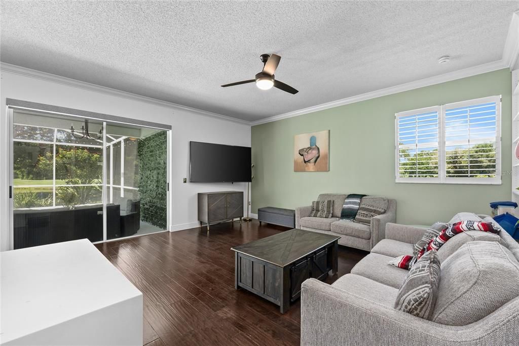 Living Room with Plantation Shutters and a view of the Pool