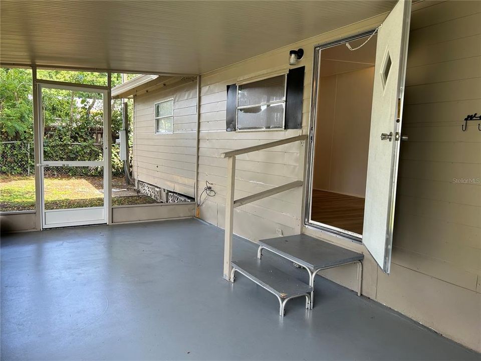 Screened in back porch with access to laundry room.