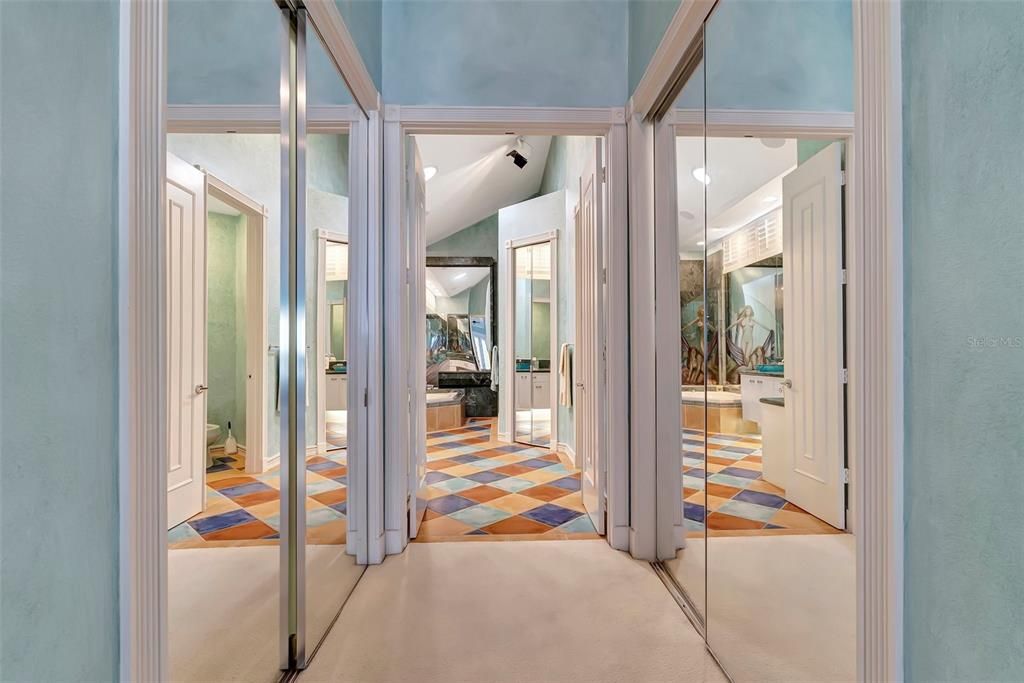 Hallway from Primary bdrm to primary bath flanked by walk-in closets