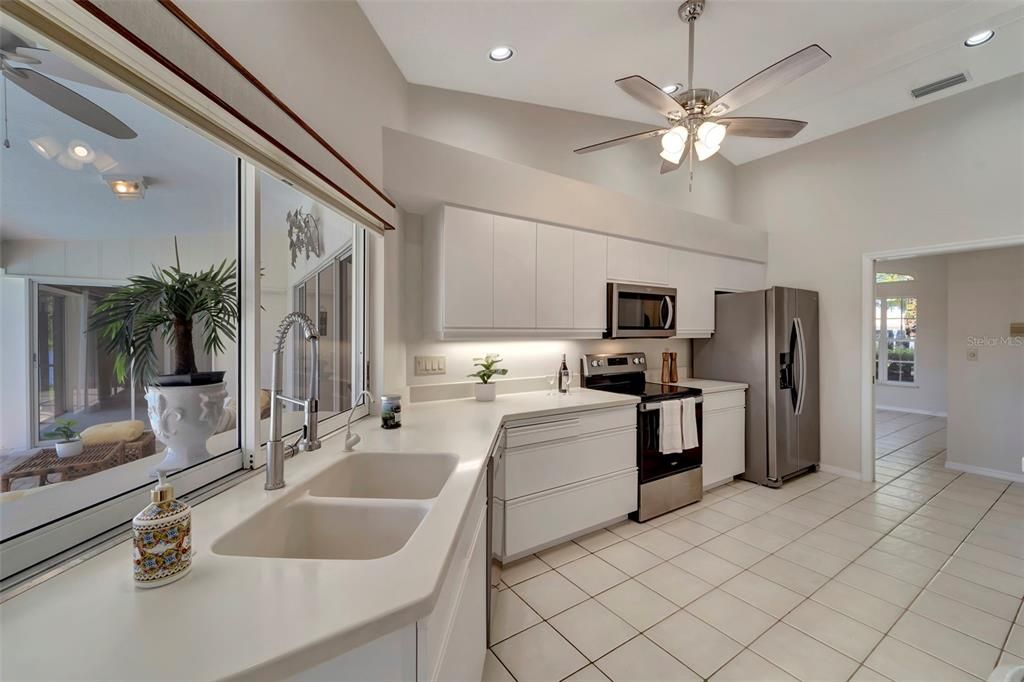 Kitchen with large windows overlooking pool and pond