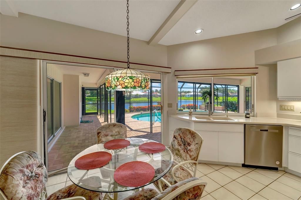 Breakfast area & sliders in kitchen & hallway for easy access to the pool and lots of natural light