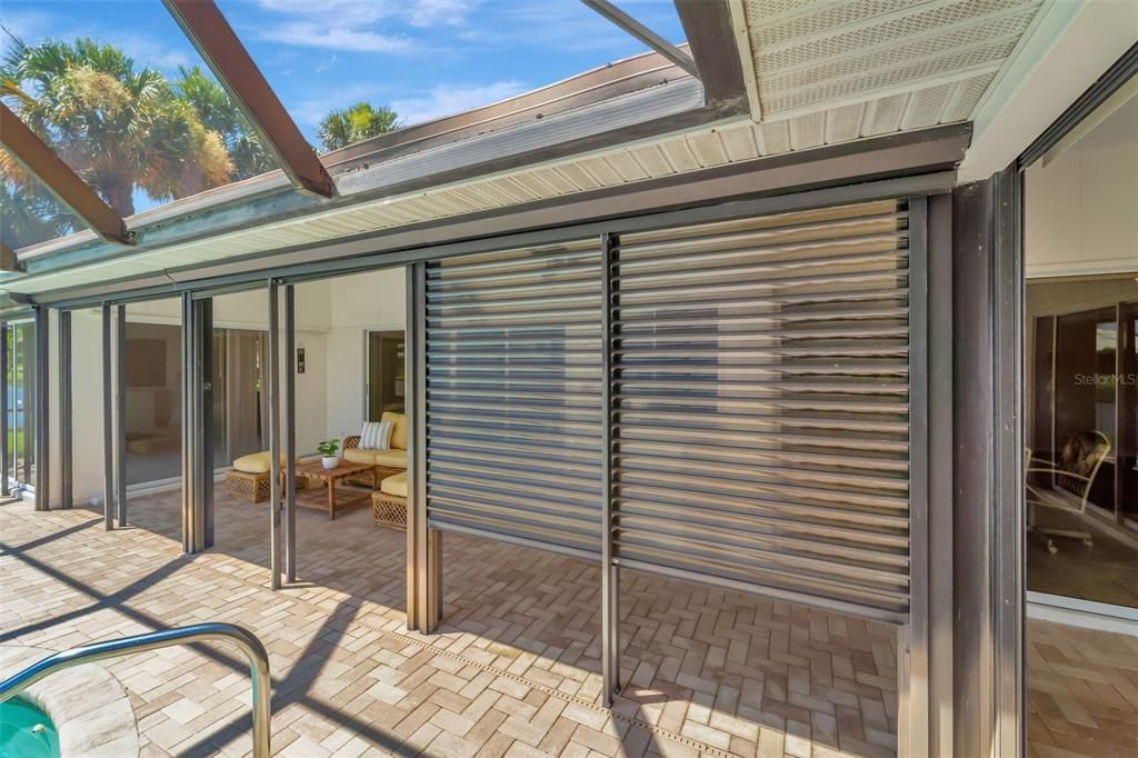 Electric hurricane shutters throughout pool patio, and hurricane shutters for rest of the house, front door