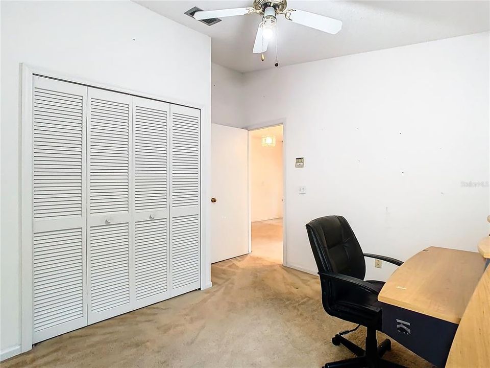 Bedroom 3, built in closet to left, entry door in center of shot