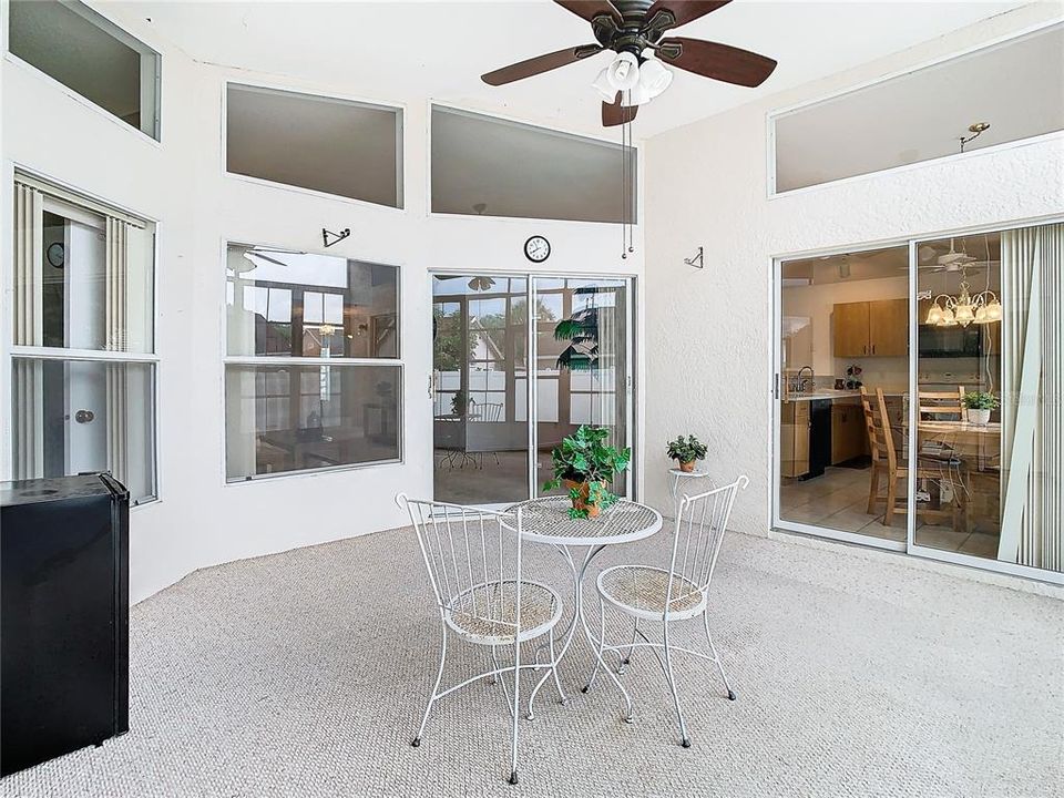 Lanai, living room sliders in center, sliders to kitchen and breakfast nook to the right