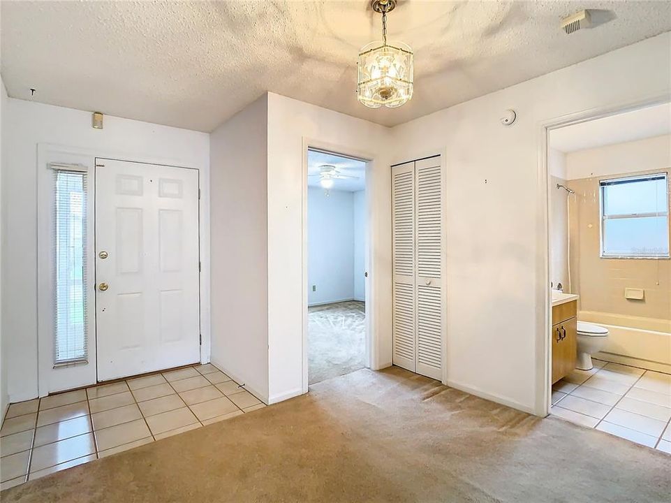 Entry way, view of front door, bedroom 2 and hall bath