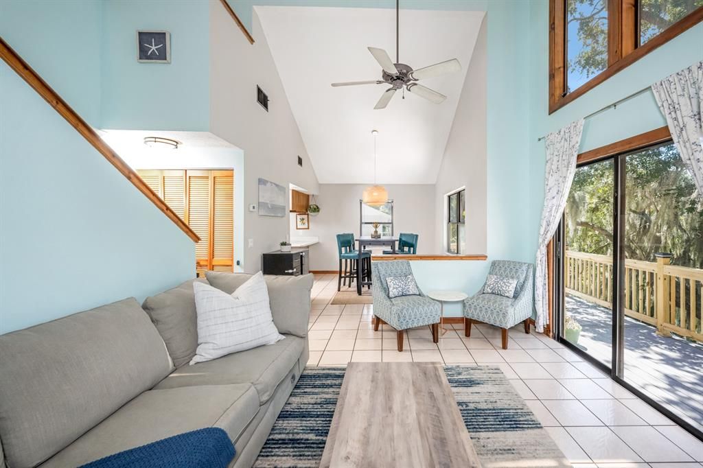 High vaulted ceiling combines family room with slider door to deck