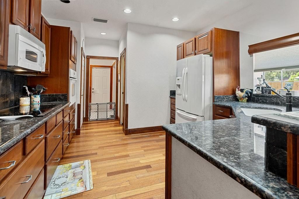 Large kitchen with plenty of counter space and ALOT of cabinets.  The kitchen window over the sink overlooks the fenced in back yard.