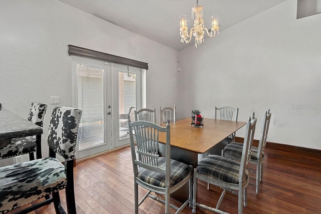 dining area in great room with French doors to covered lanai and large back yard.