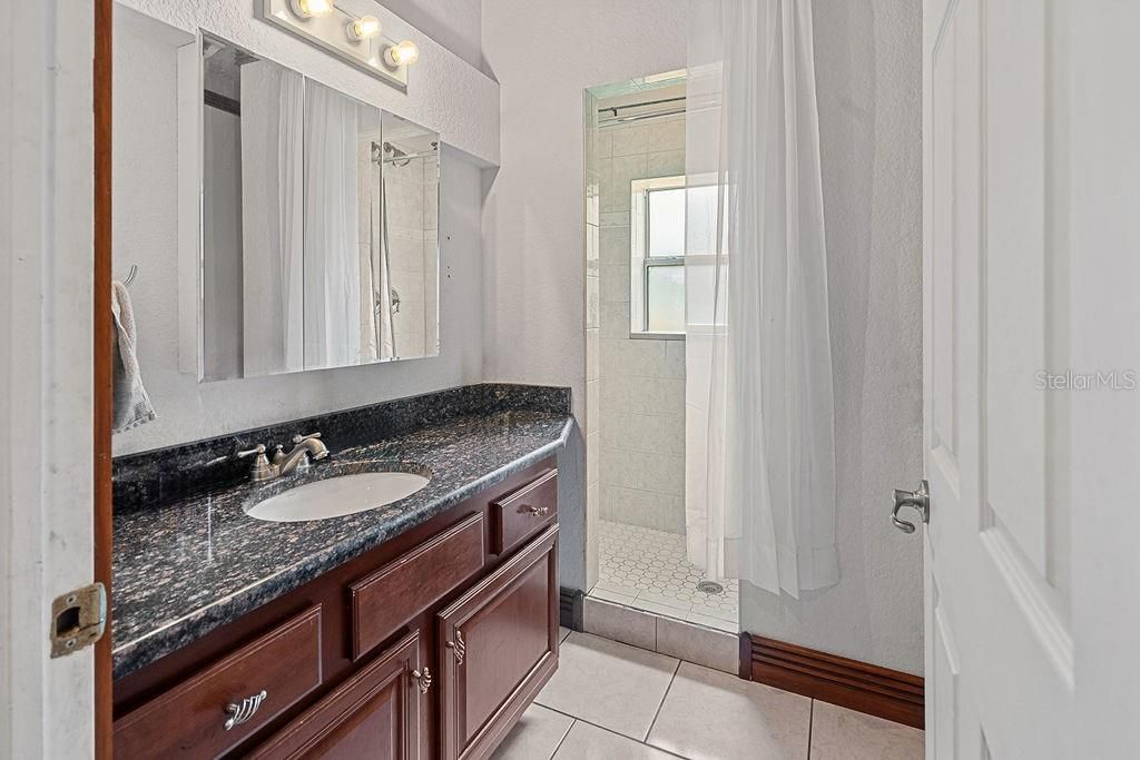 The en-suite primary bathroom features a large walk in shower