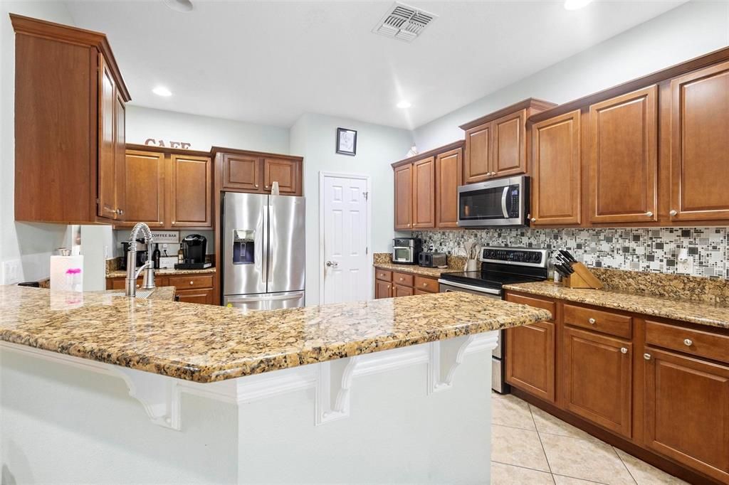 Granite tops, solid cabinets, breakfast bar, stainless steel applicances and pantry are the highlights.