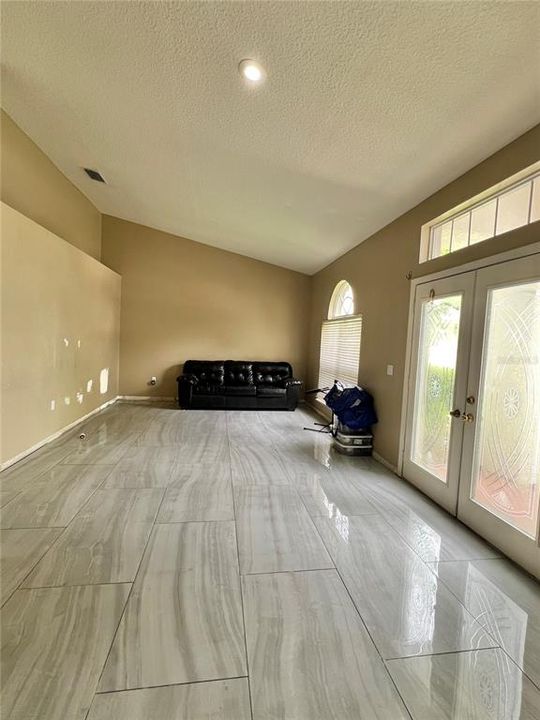 Front living room with ceramic tile flooring.  There are 3 large piles of this flooring in the garage.