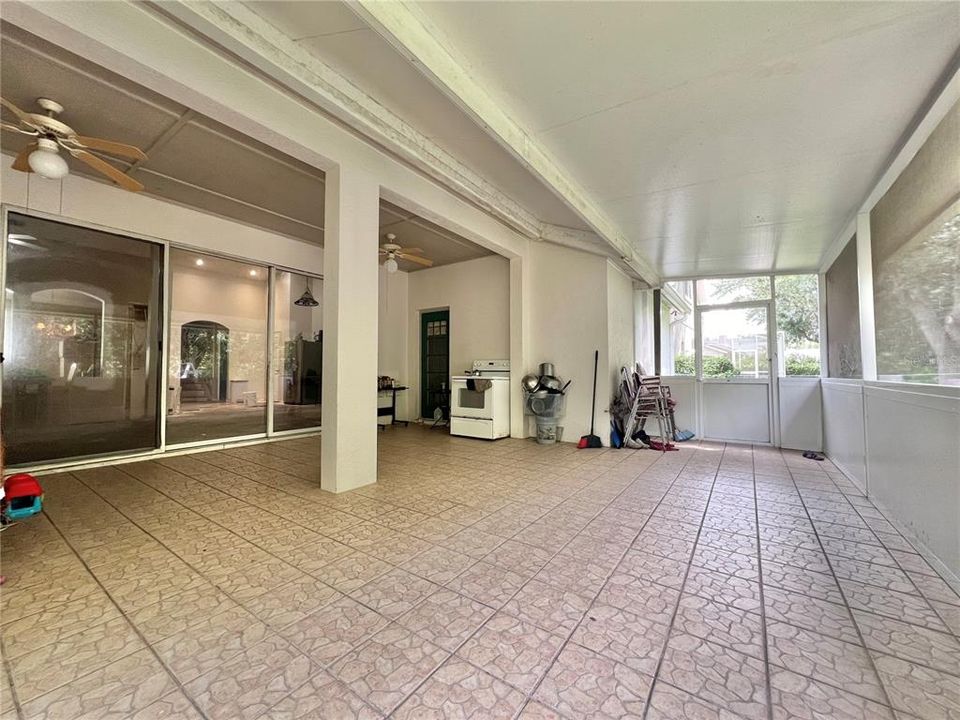 Screened-in back porch has ceramic tile flooring (small leak in porch roof at joint)  Two screen exit doors.