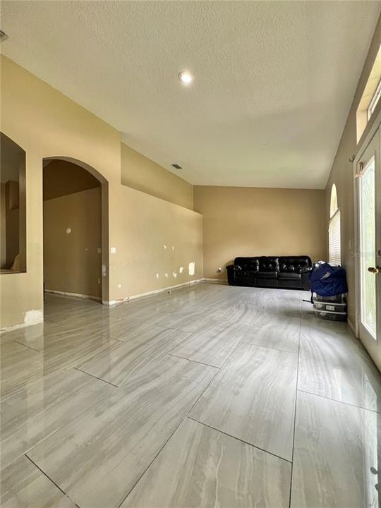 Front living room with ceramic tile flooring.  There are 3 large piles of this flooring in the garage.