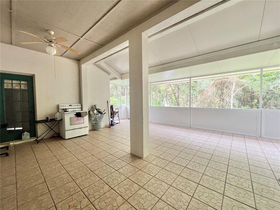 Screened-in back porch has ceramic tile flooring (small leak in porch roof at joint)  Two screen exit doors.