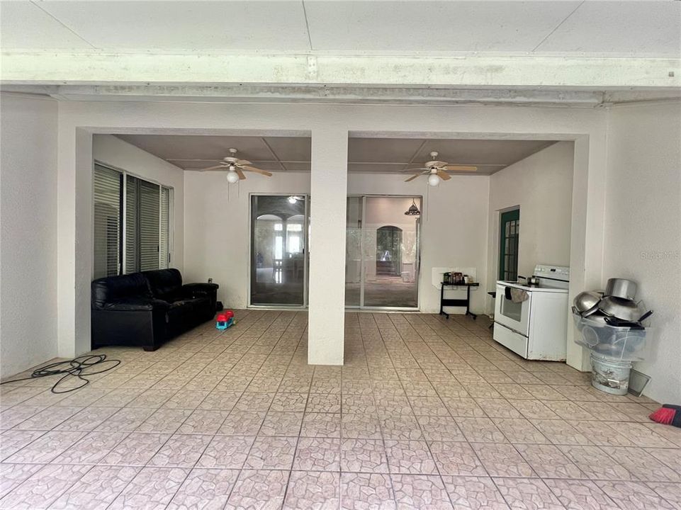 Screened-in back porch has ceramic tile flooring (small leak in porch roof at joint)  Two screen exit doors.