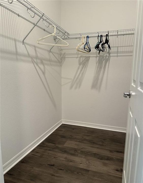 Primary bedroom walk in closet