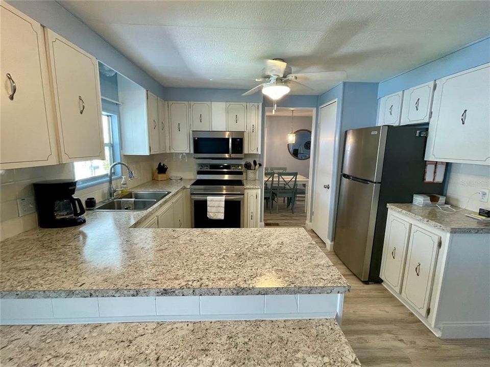 Kitchen - newer countertops and set of 4 SS appliances... ample amount of counter space in this sizable kitchen.