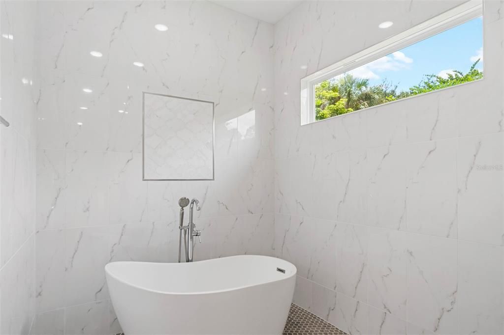 Master suite shower room with standing tub