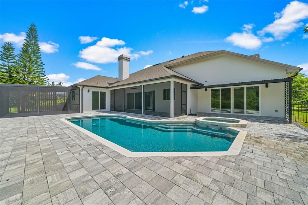 View of house with pool, porch and spa