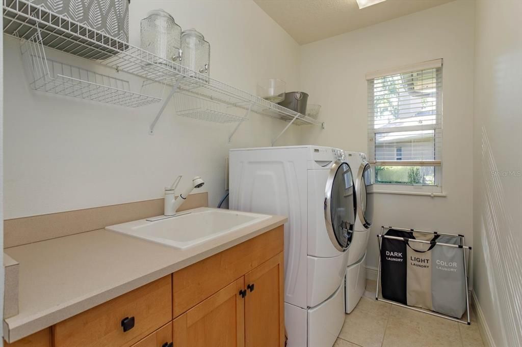 Laundry room with sink and storage closet