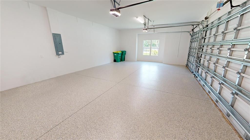 Three-car attached garage with epoxy floor