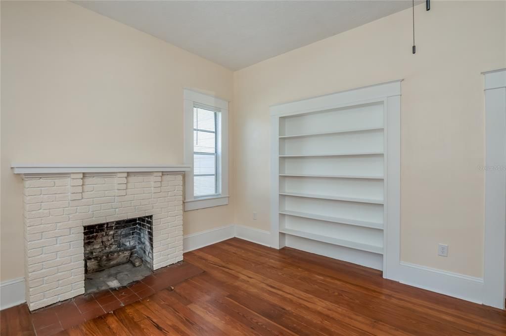 Living room with built-in shelving and decorative fireplace