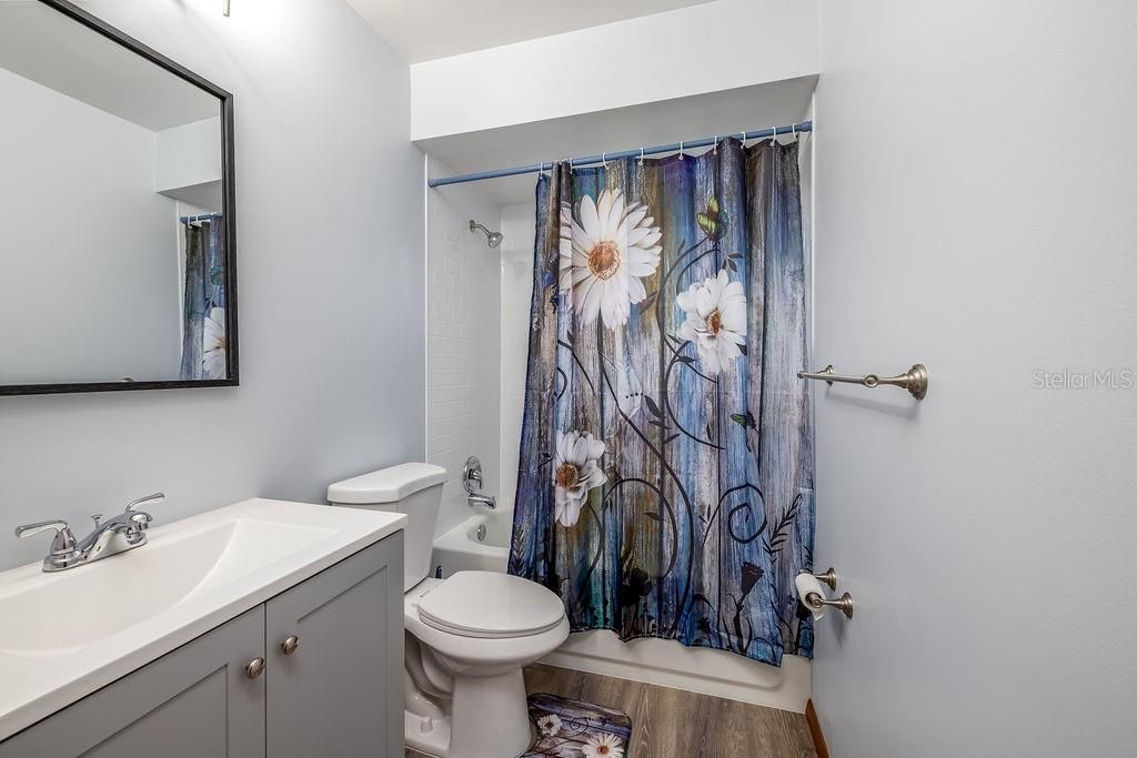 NEW NEW NEW Guest bath newly redone top to bottom! Tub/shower combo, commode, sink & vanity, lighting & mirror!