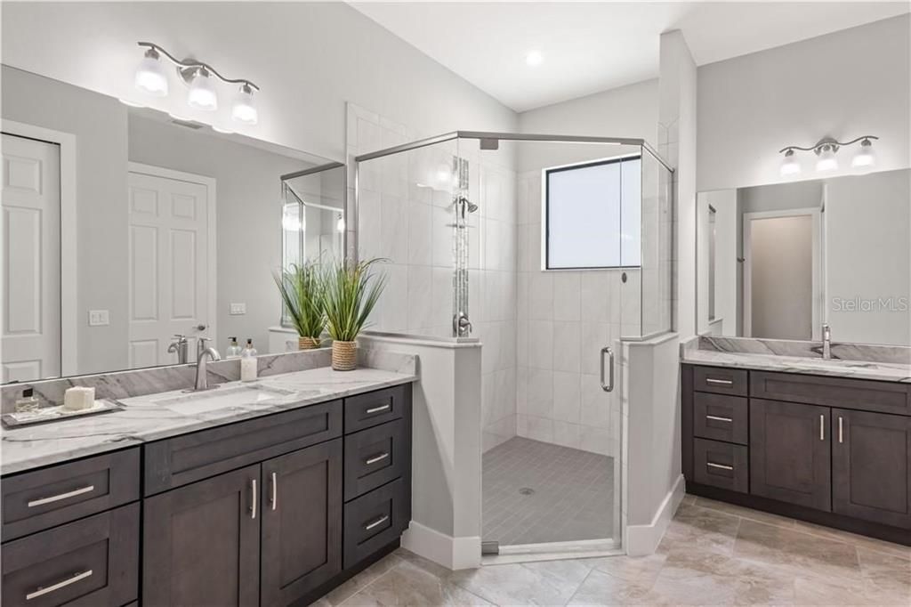 Master bathroom features dual sinks with their OWN vanity.  Super large shower with glass enclosure and large cabinets for towels etc.