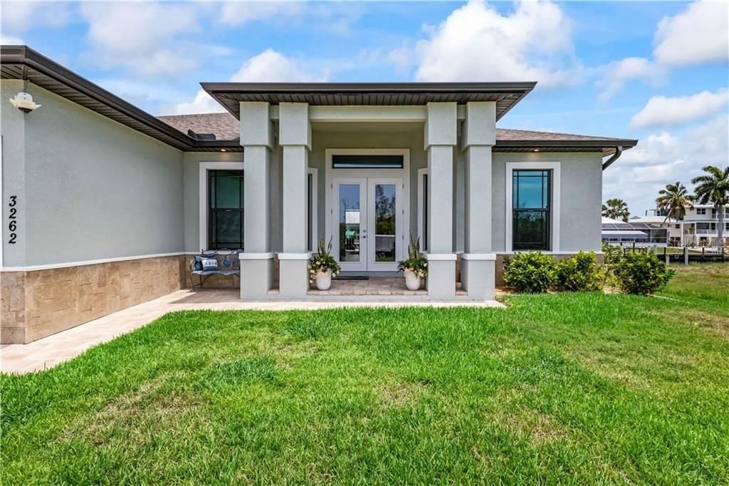 Paved walkway to columned entrance - curb appeal at its best!