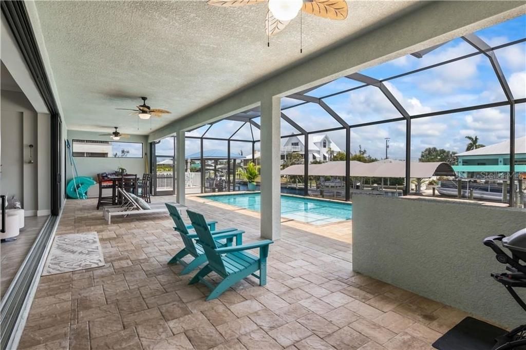 A privacy wall and  plenty of room for an outdoor kitchen!  Sparkling pool and spa combo are ready for you to kick back and relax in!