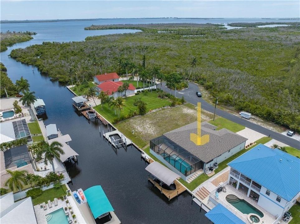 LOCATION LOCATION LOCATION!  What an incredible opportunity to live on such a wide canal aptly named Manatee Canal, with DIRECT ACCESS out to the water!  A custom home on a quiet culdesac with an additional parking area across the road!  A wonderful opportunity to join the vibrant Island life and live your best life!