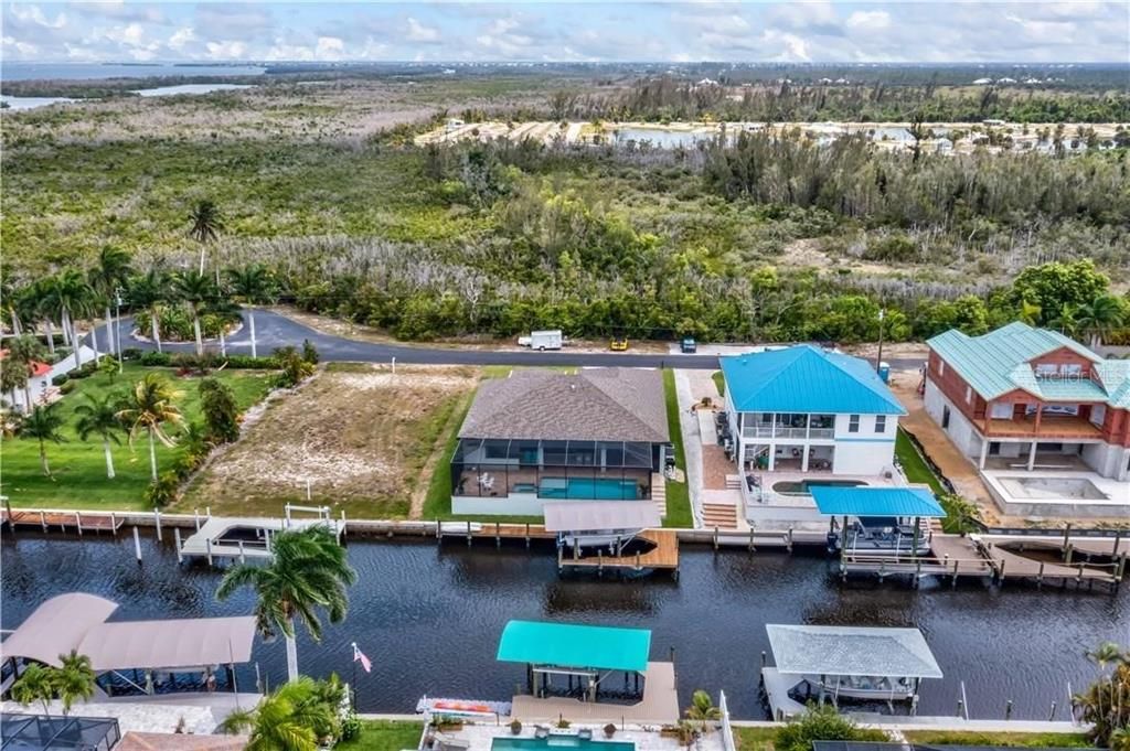 Birds eye view of property - wide canal, established neighborhood, close to many restaurants yet surrounded by nature.