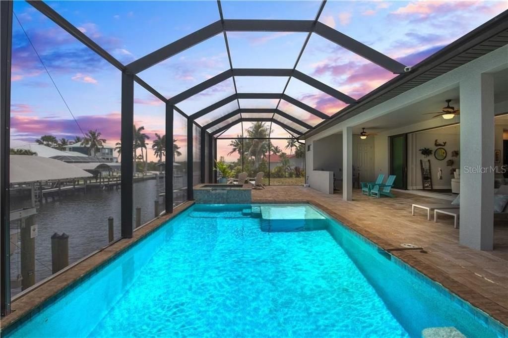 Pool at dusk  looking east - the Manatee Canal is known for its vibrant water life - chances are you will get a visit or more every day from the dolphins and manatees that call these waters home!  A glorious location on the island!