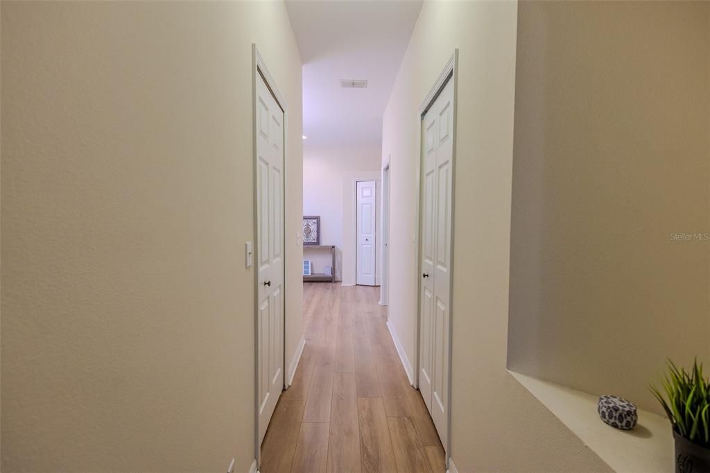 Hallway with both walk-in closets