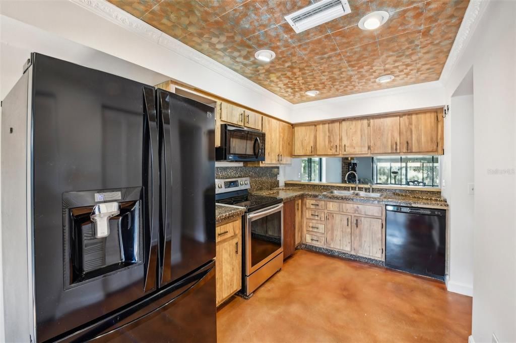 Start your tour in the EAT-IN KITCHEN offering a comfortable layout, quality appliances and a pass through/breakfast bar connection to the dining area.