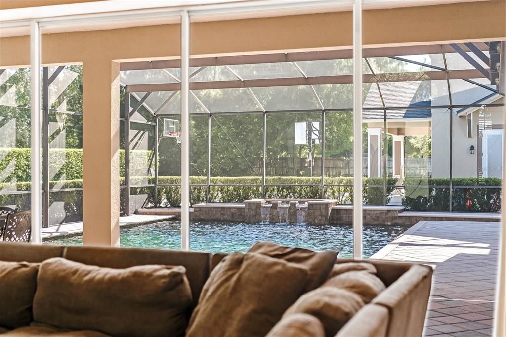 Enjoy views of the screened in pool and the nature that surrounds this amazing home.