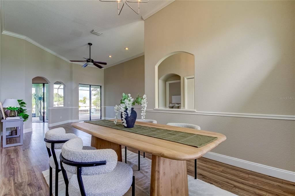 Dining room looks toward family room and out to pool.