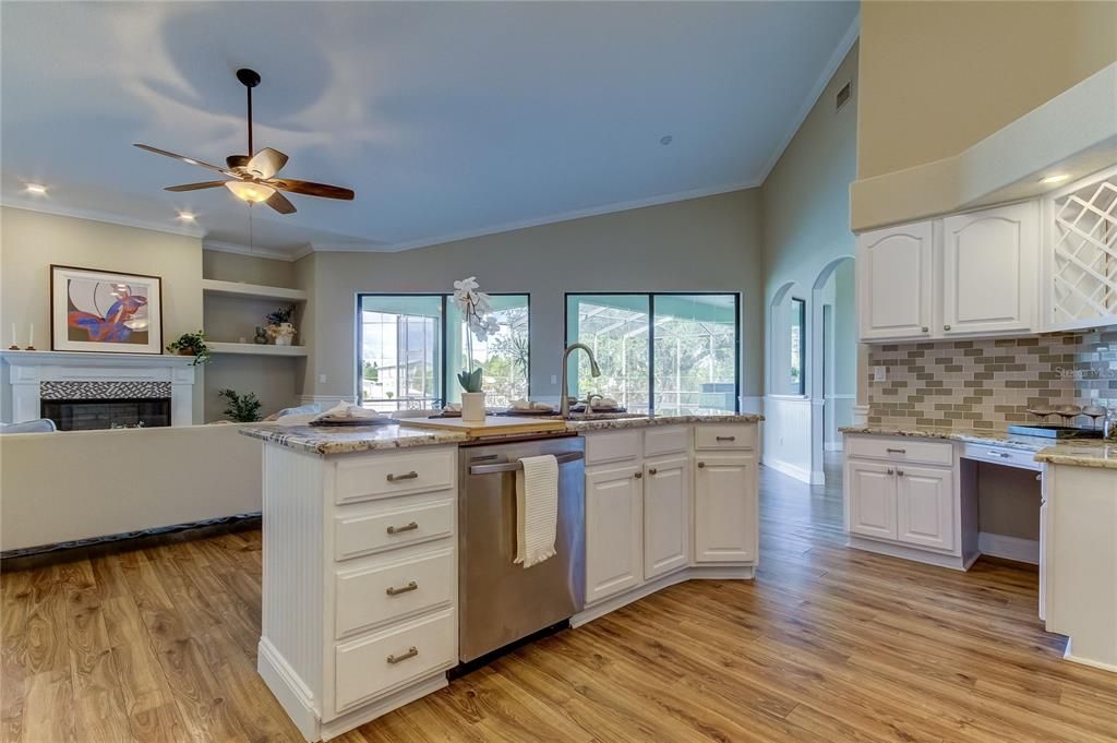 Kitchen looks over the living room, and out onto the pool.