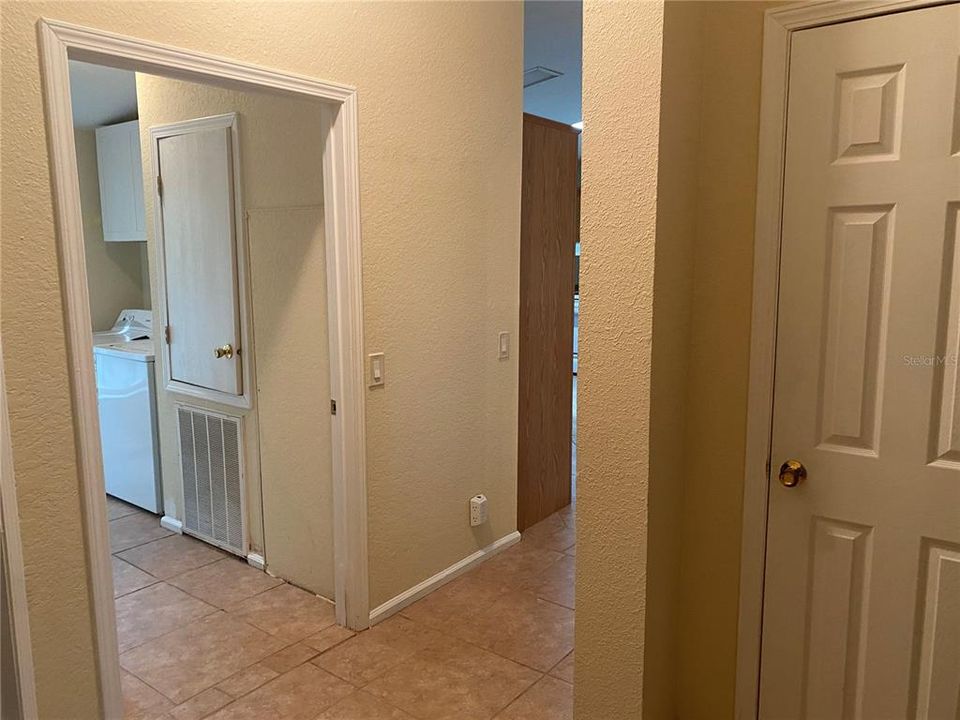 View from dining room into hall and kitchen