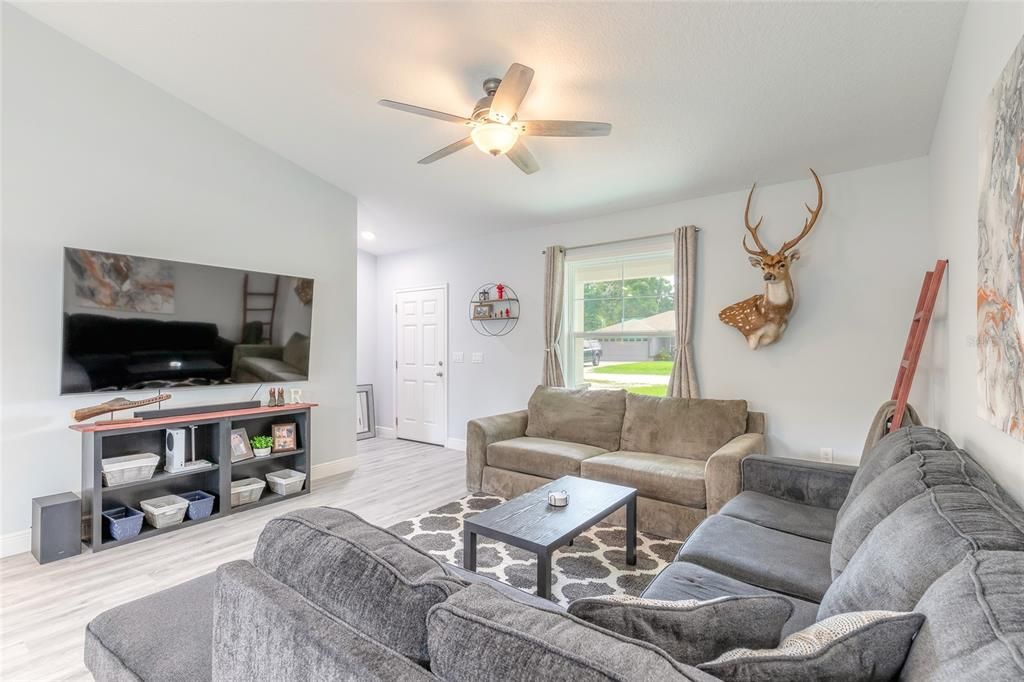 View in living room toward front door entry