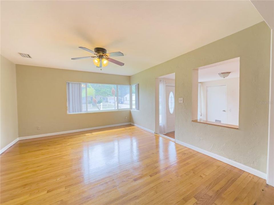 View of living room with view of front door and pass thru window....