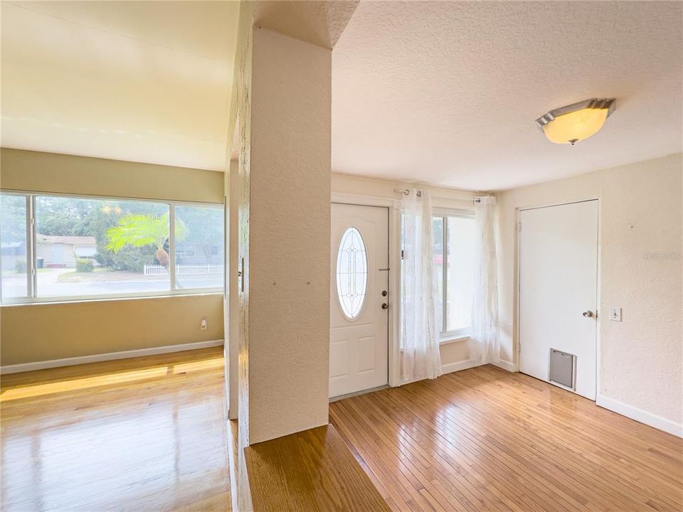 Split View of great room and living room and front entrance door...