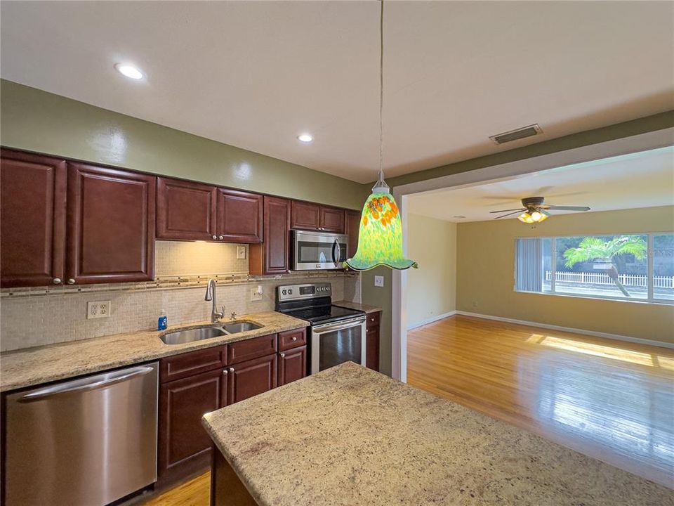 View of kitchen and living room and beautiful window overlooking the beautiful front lawn....