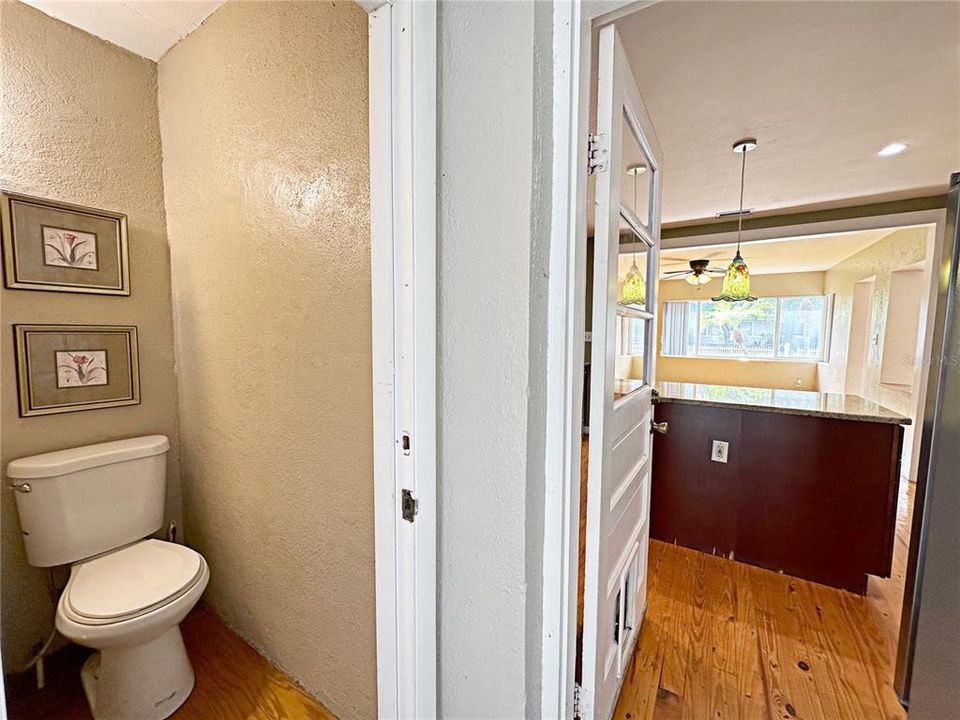 View of half bath and rear entrance to the main home kitchen