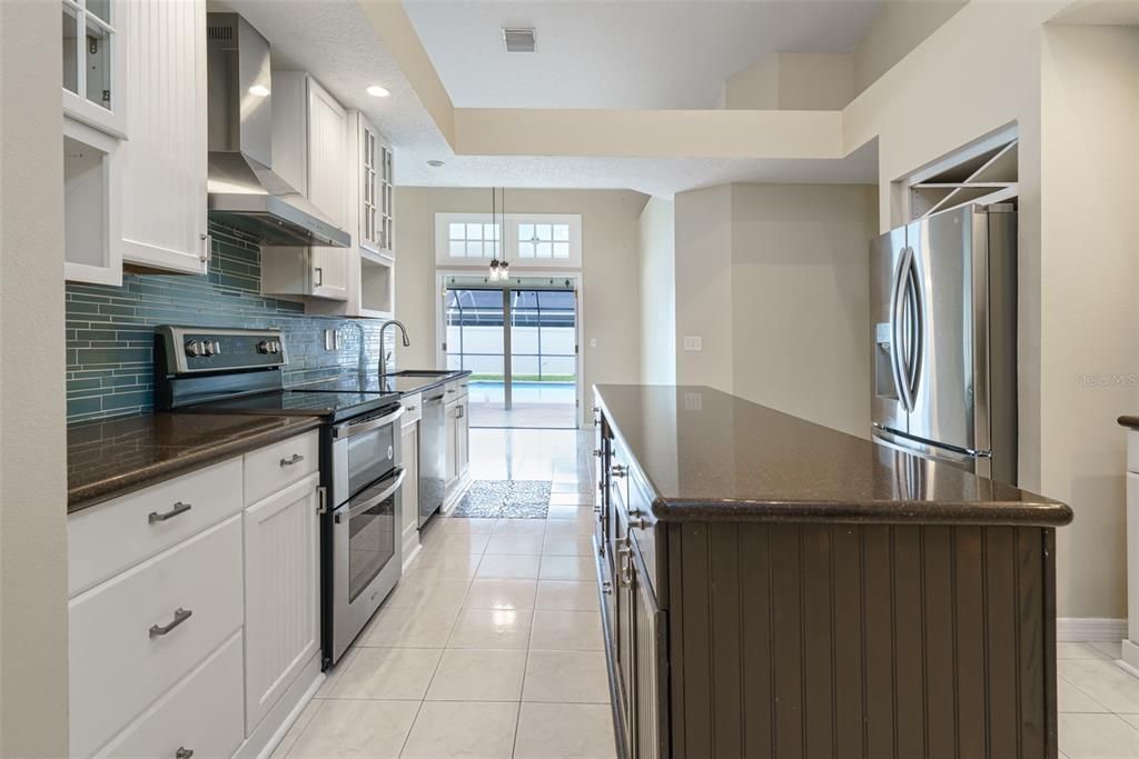 Kitchen with island and eating space in the background.