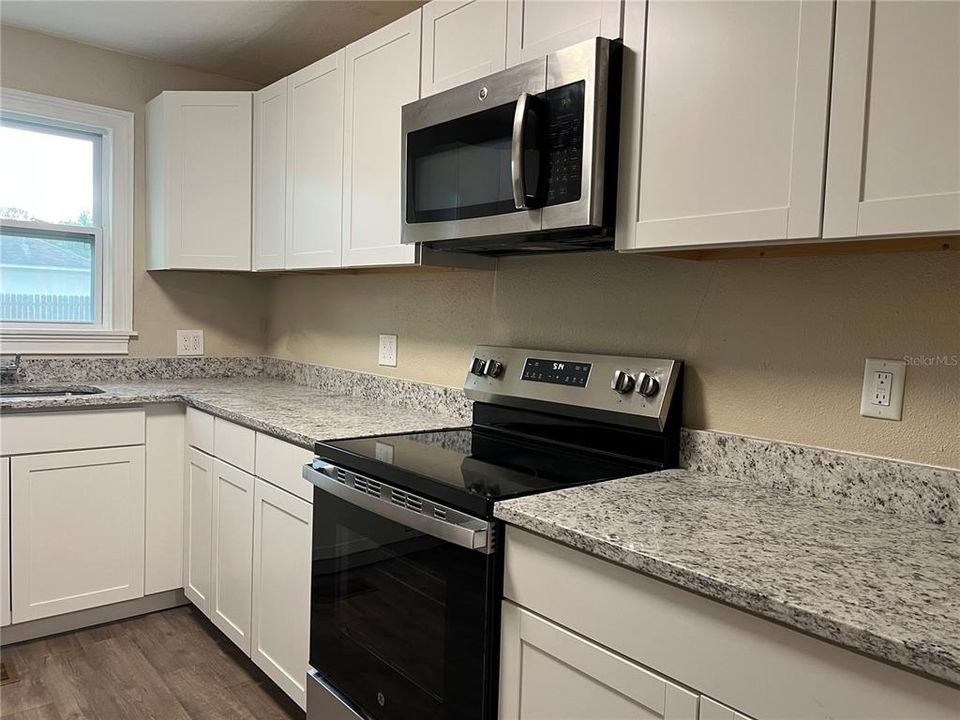 Wall to wall cabinets on both sides of kitchen