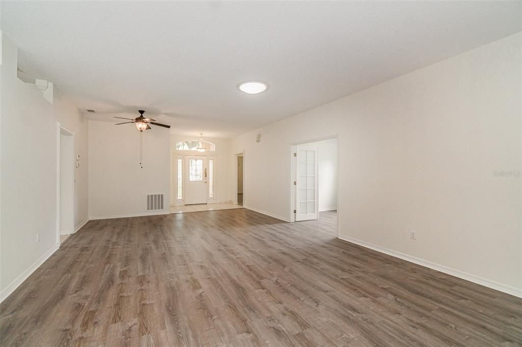 Living /Dining looking towards entrance and view of family room and kitchen