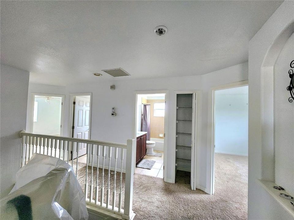 at top of stairs there is a bedroom to the right then 2 bathrooms and 2 bedrooms to far left