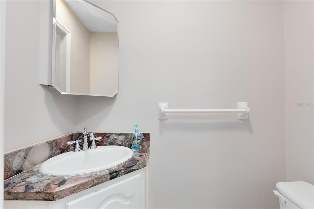 A half bath just off the kitchen is ideal for guest use.