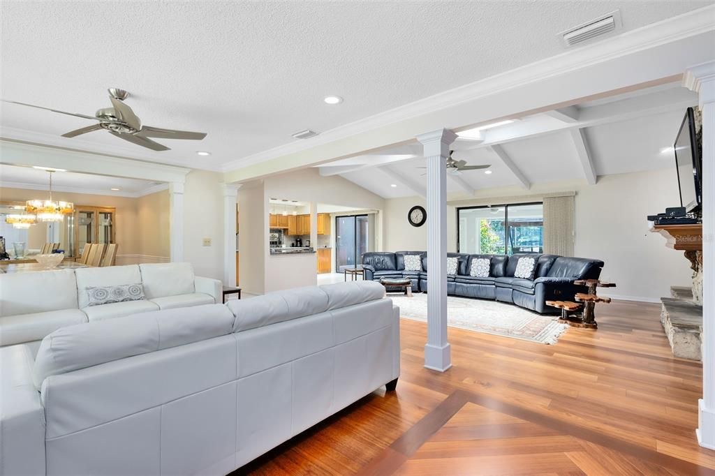 Step into a welcoming formal living room and dining room with crown molding and column accents.